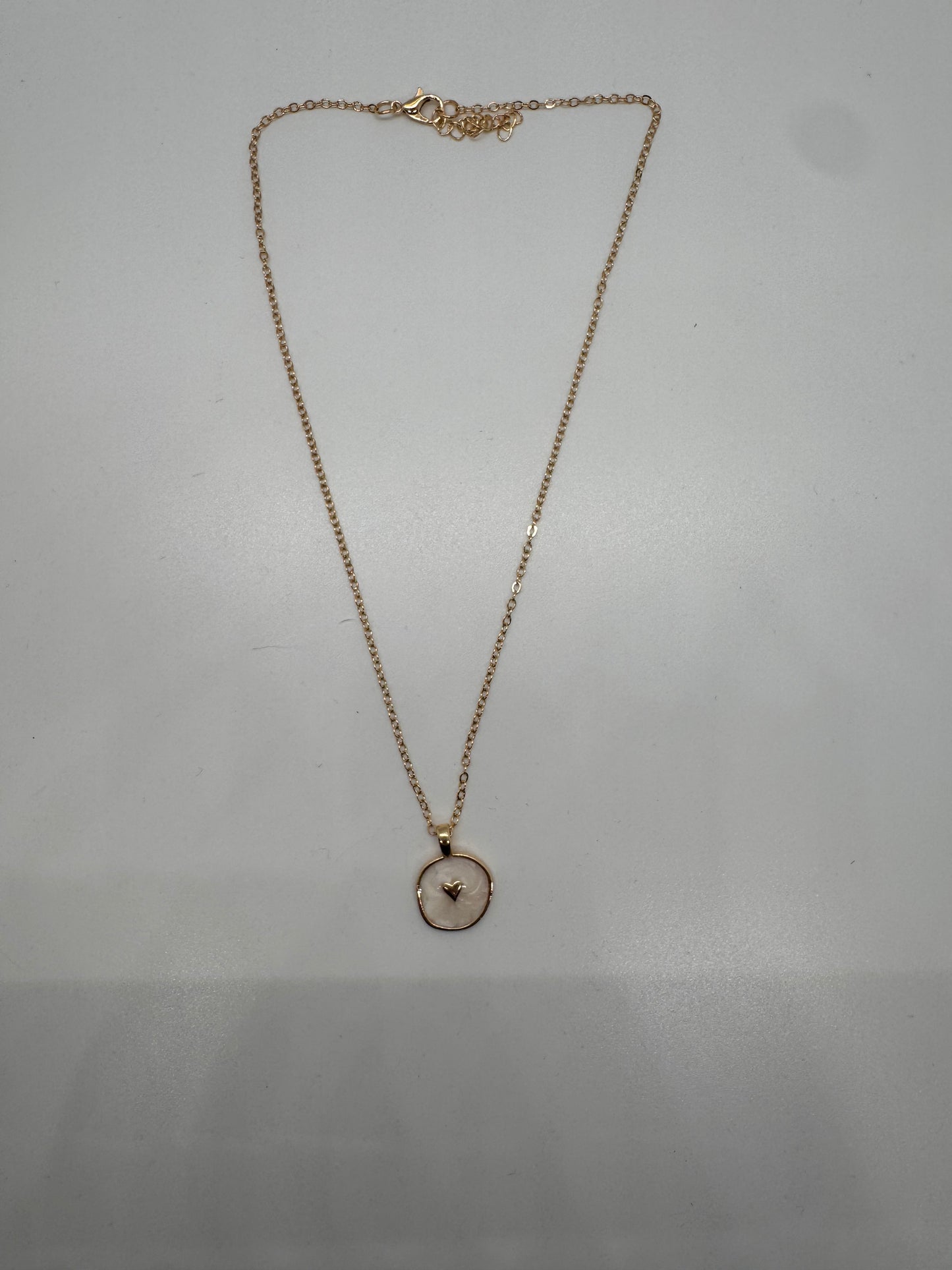 White enamel disc with gold heart