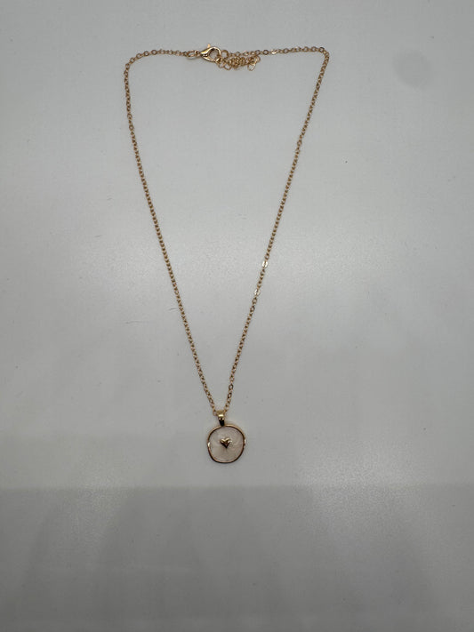 White enamel disc with gold heart